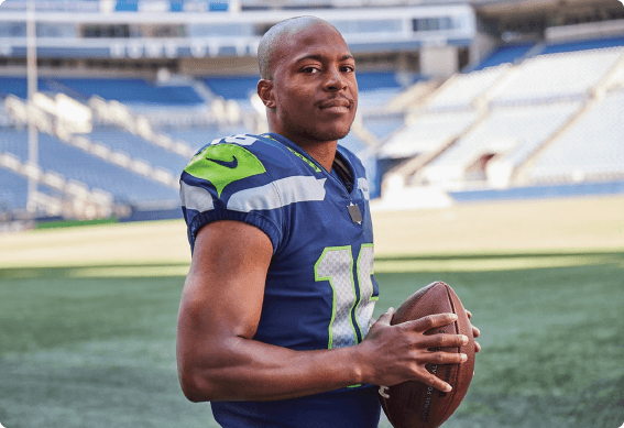 Tyler Lockett holding a football