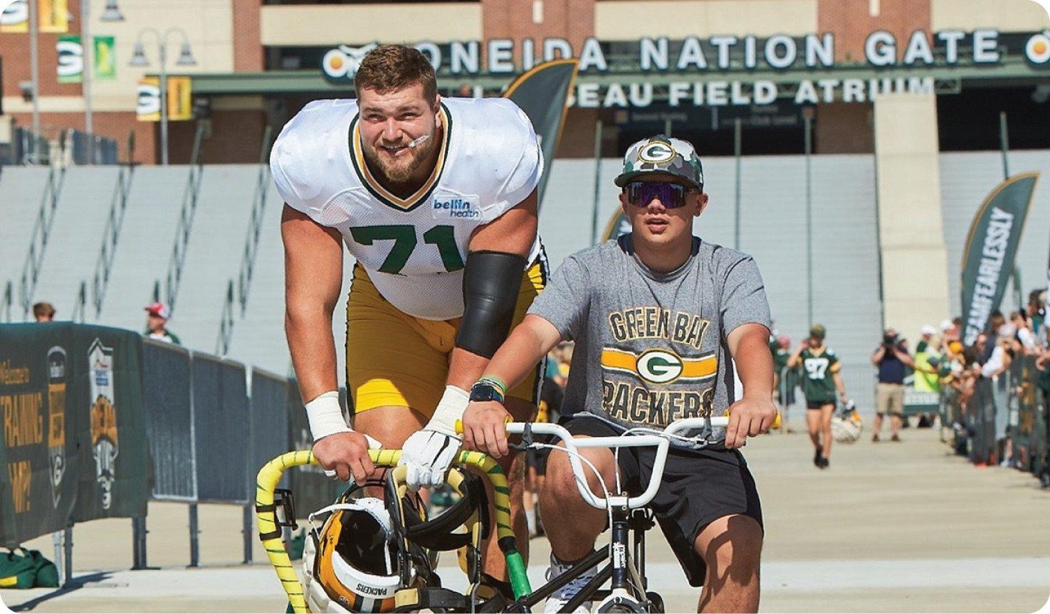 a couple of men on a bicycle