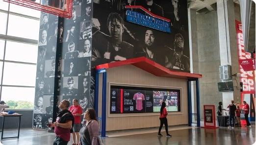 people walking past a poster