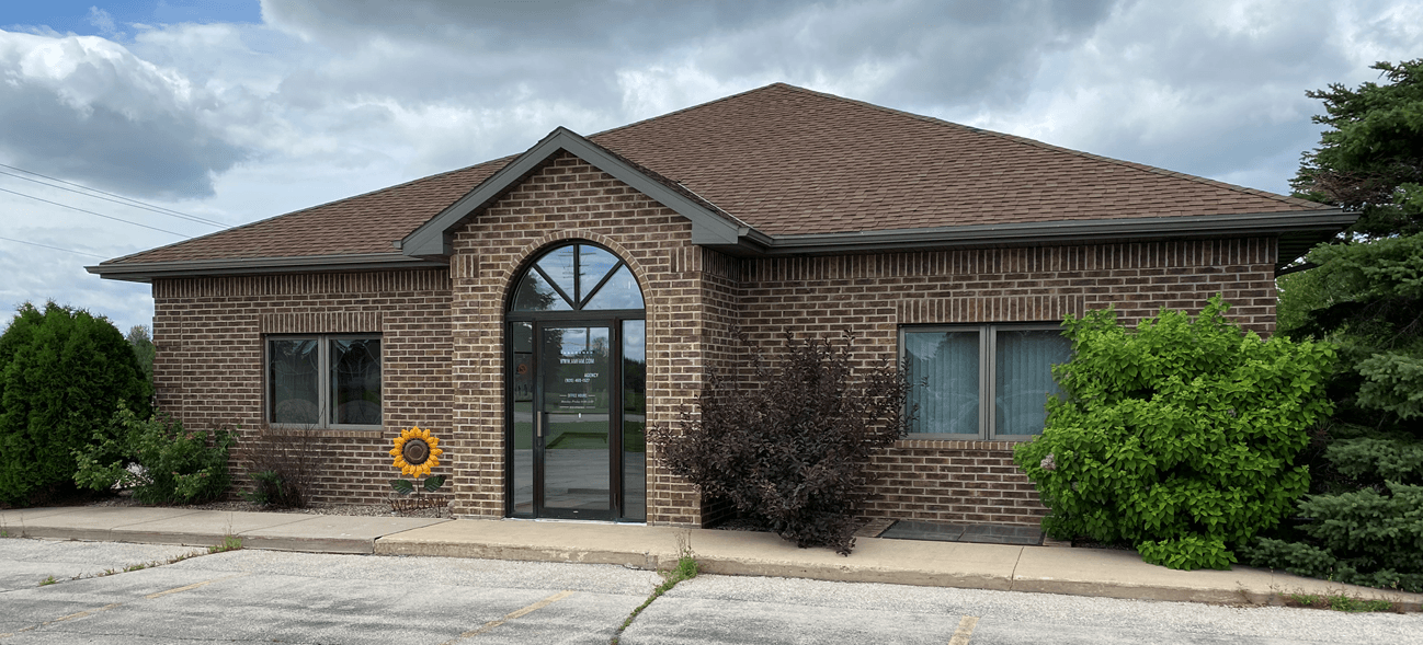 a brick house with a large front door and a large driveway