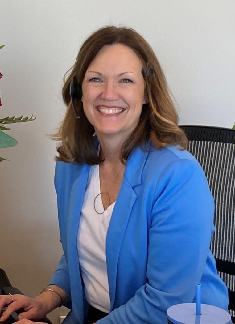 a woman in a suit smiling