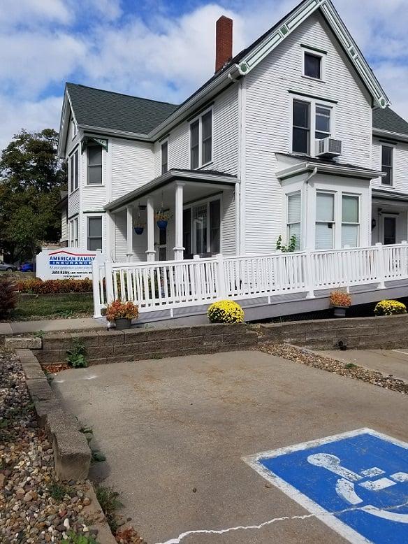 a white house with a sign in front of it