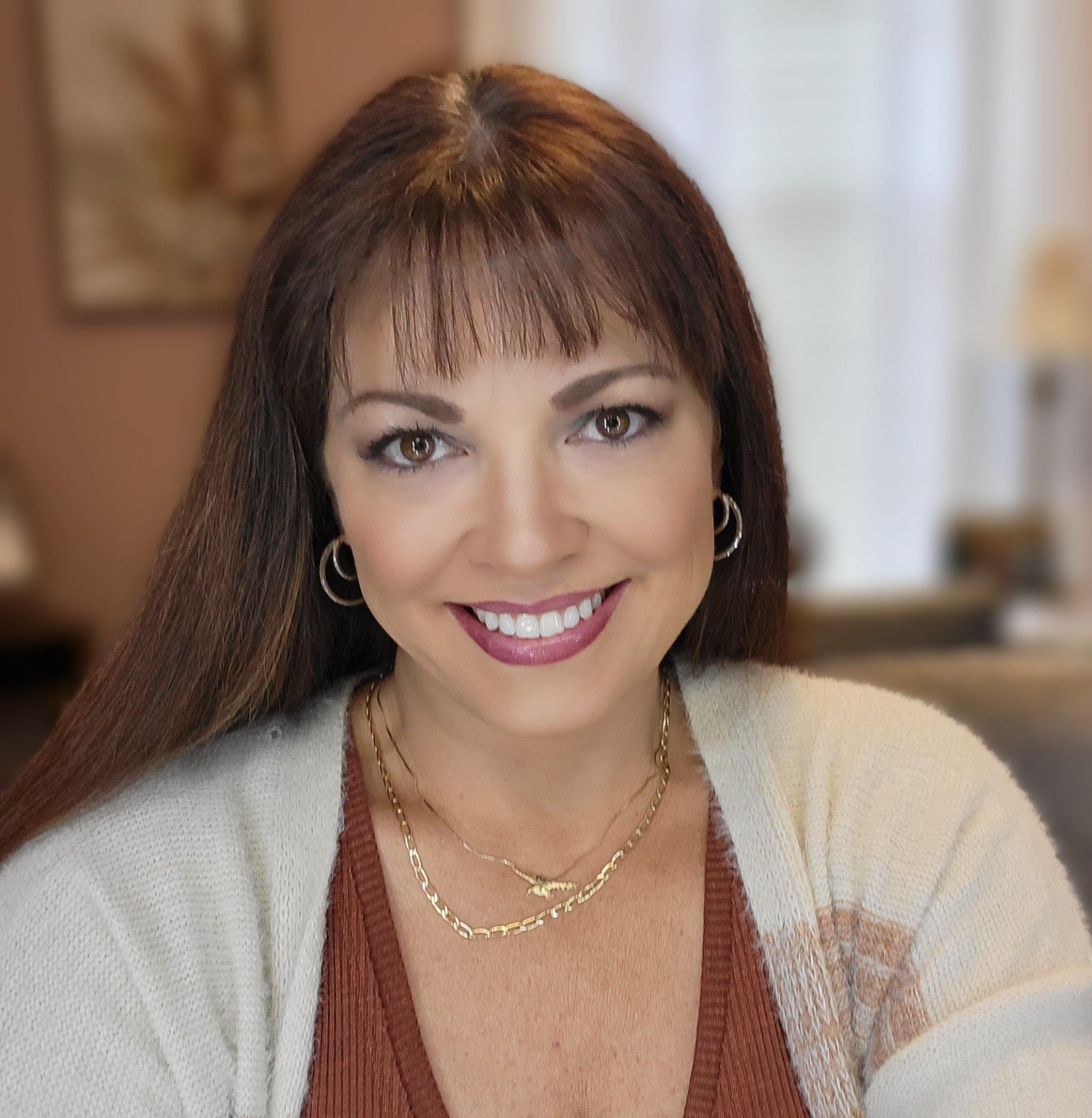 a woman with a necklace smiling