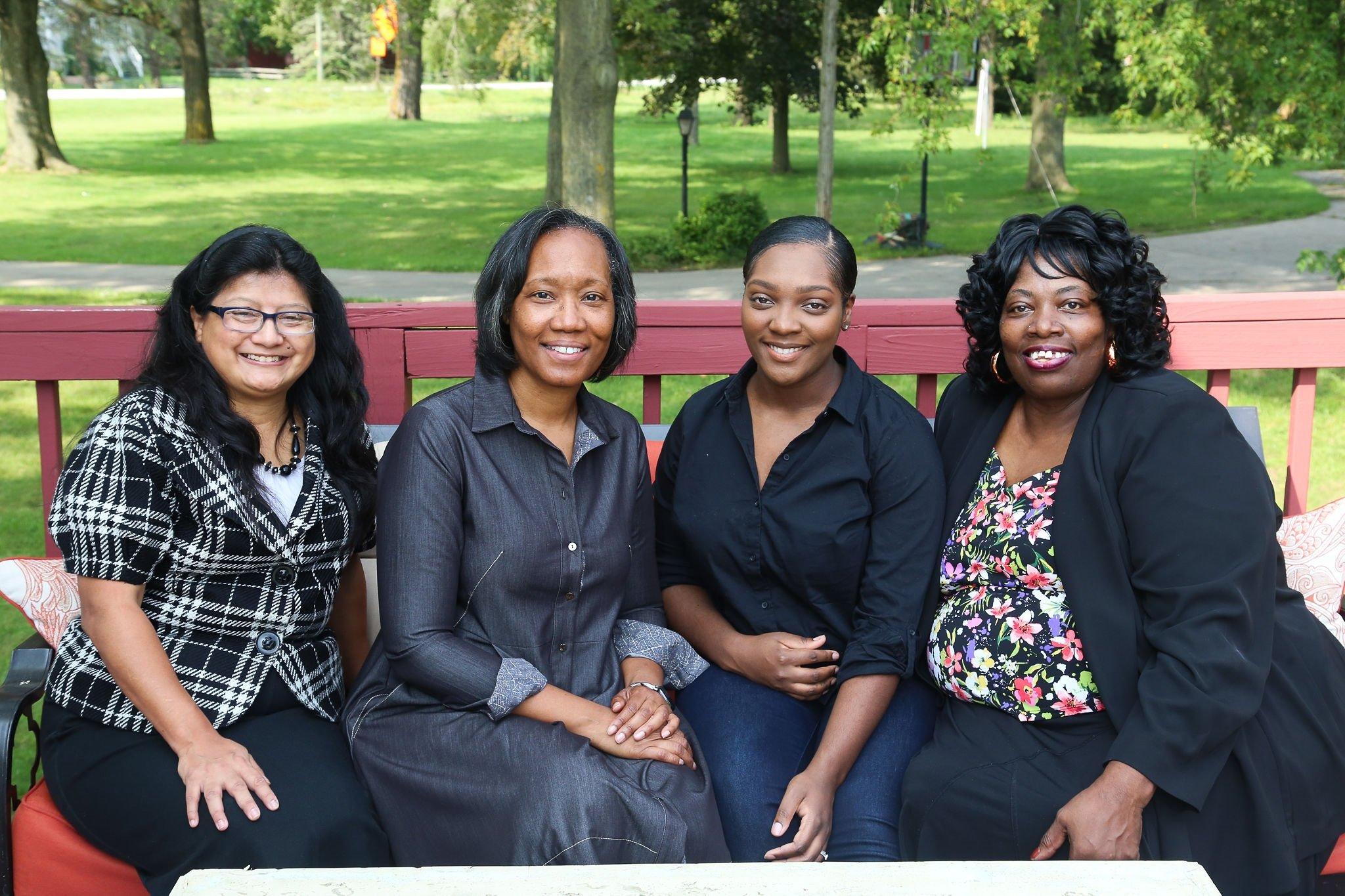 a group of women sitting on a bench