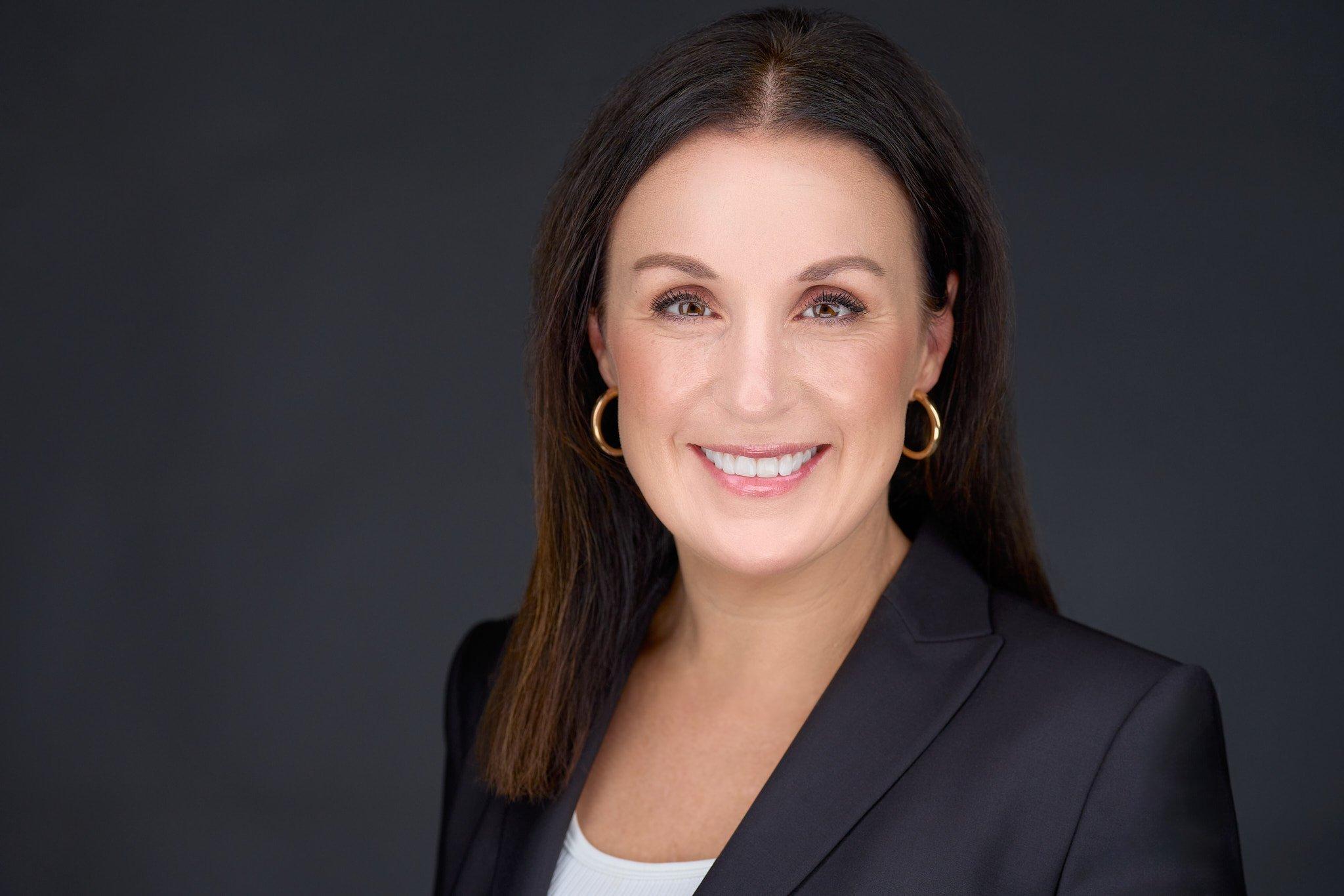 a person with earrings smiling