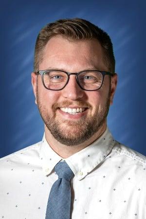 a man wearing glasses and a tie