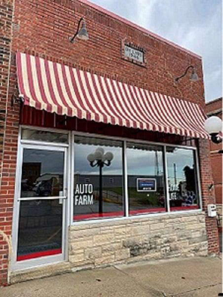 a store front with a red awning