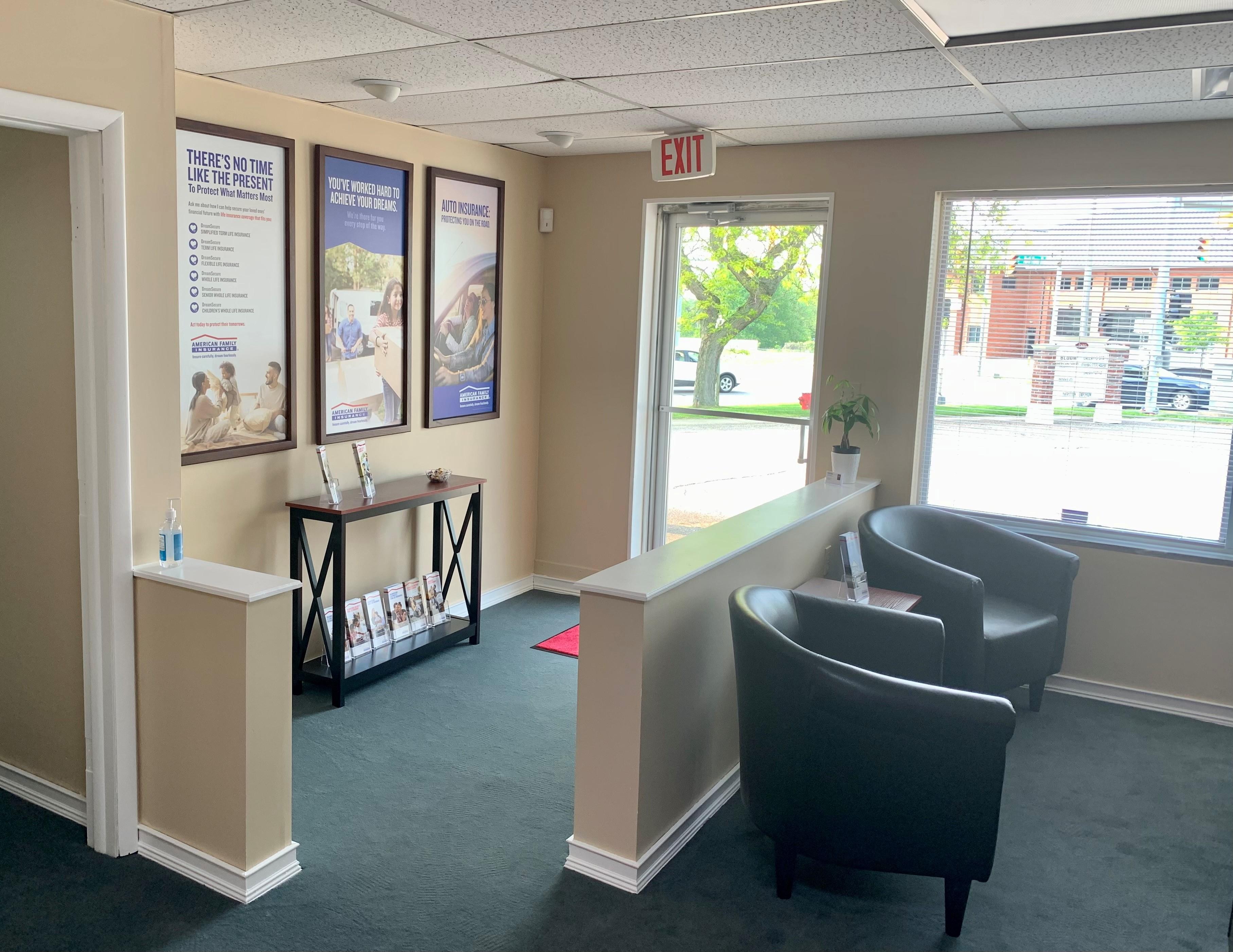 a room with a desk and chairs