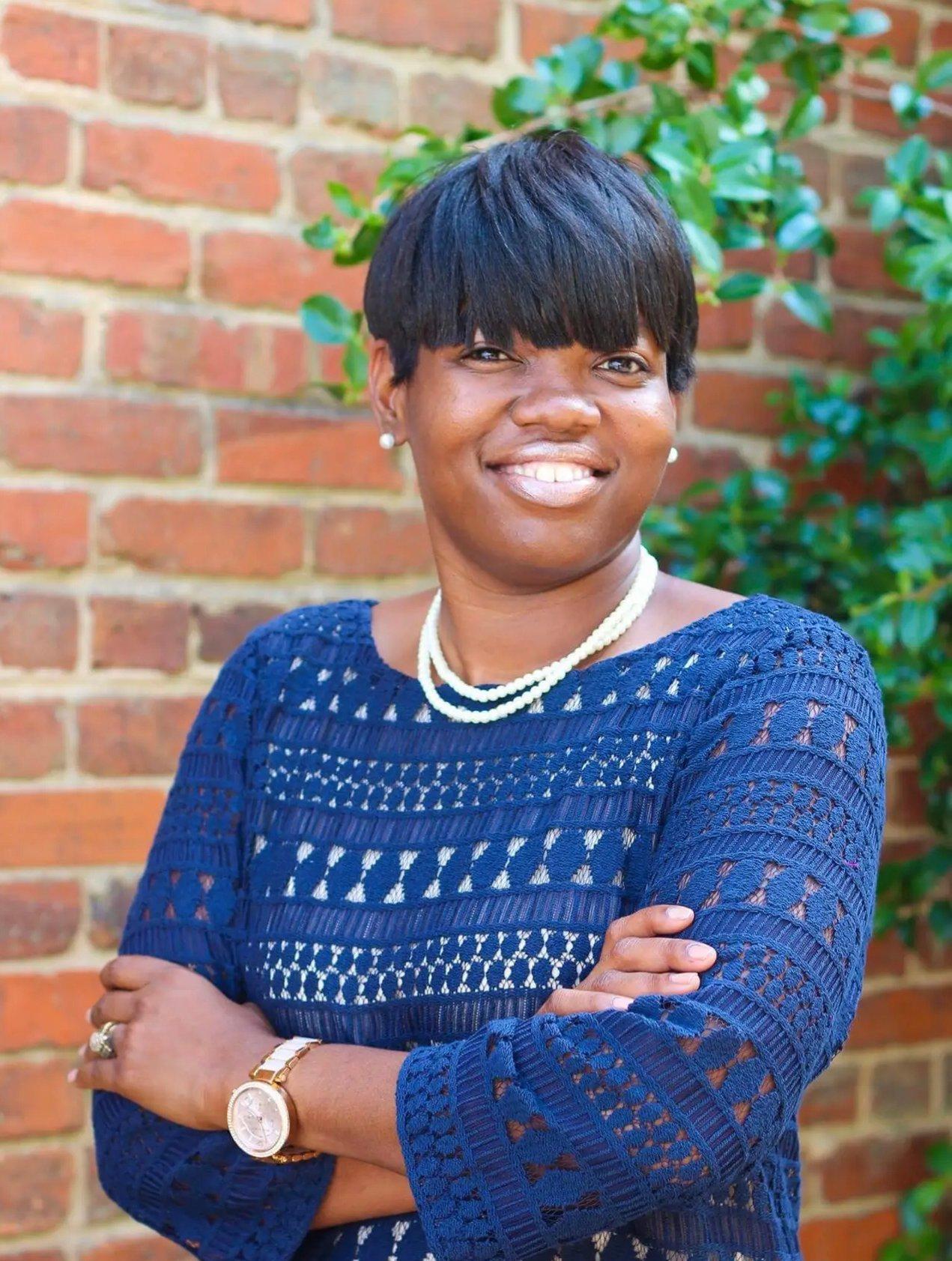 a person smiling with the arms crossed