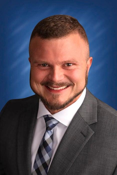 a man in a suit smiling