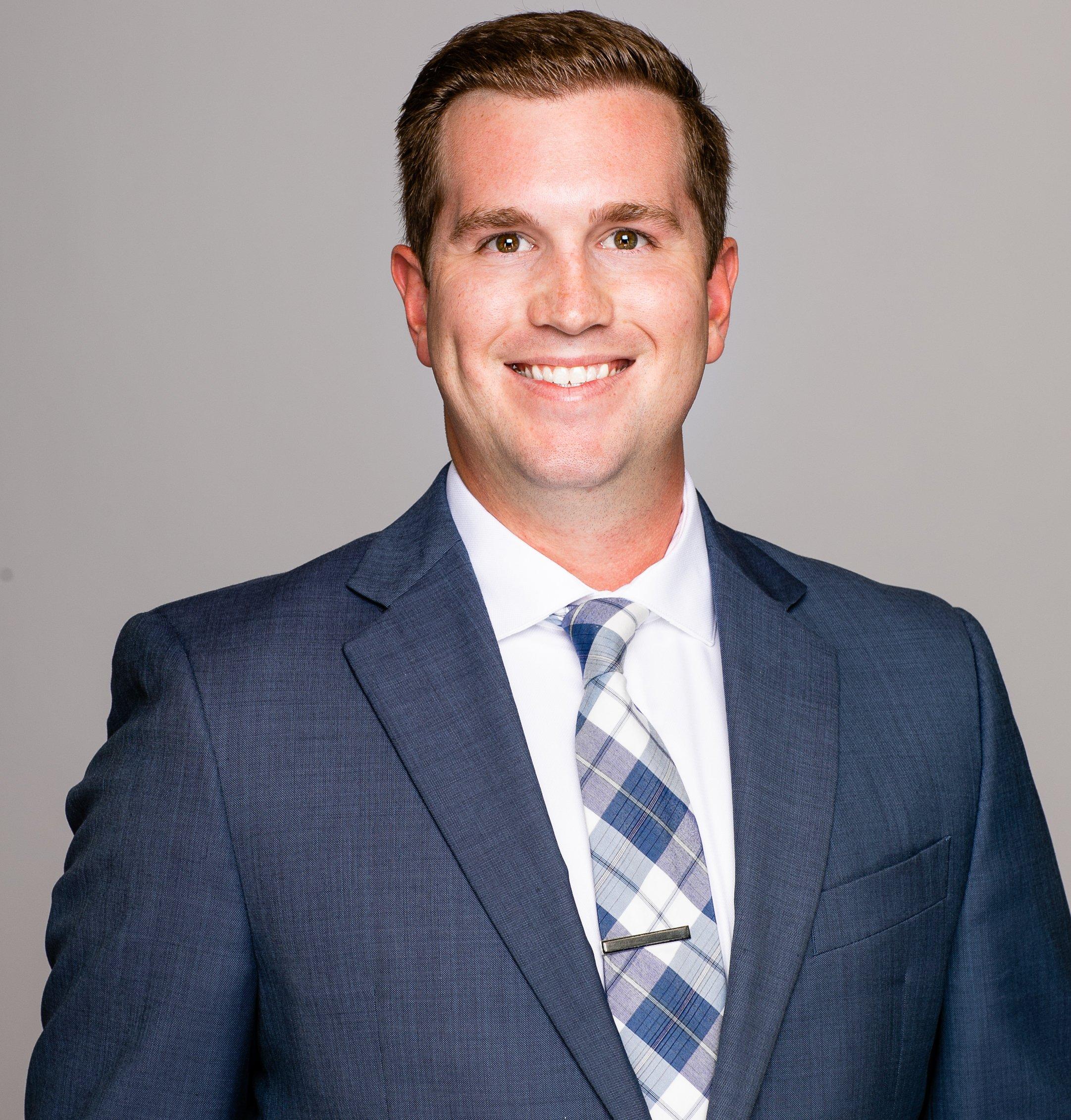 a man in a suit smiling