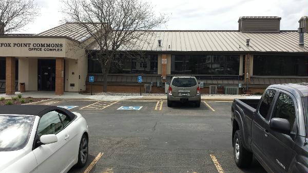 a building with cars parked in front