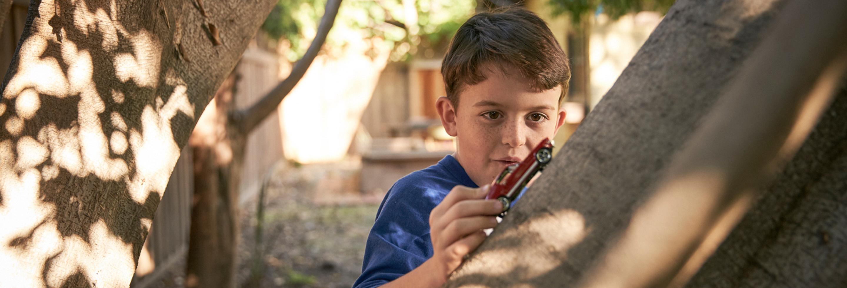 child with a toy car