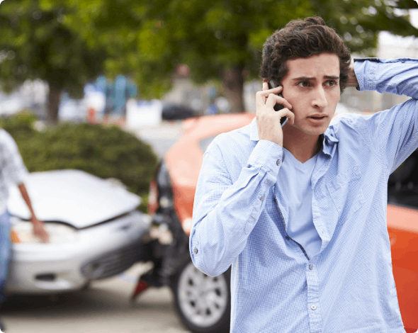 Worried driver speaking on the phone after an auto accident.
