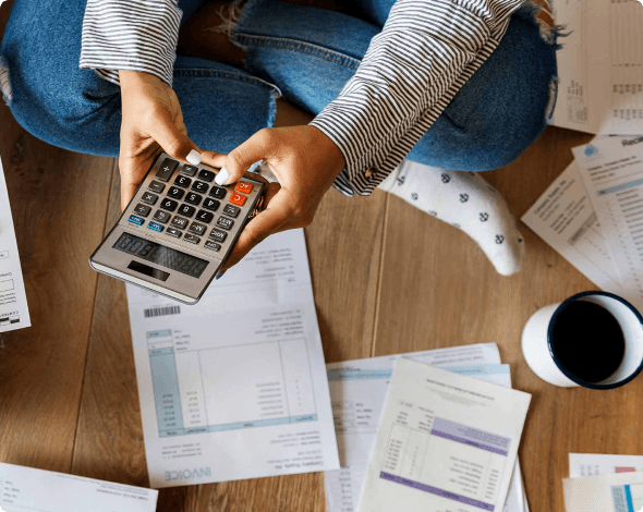 Woman sitting on the floor and going of her expenses