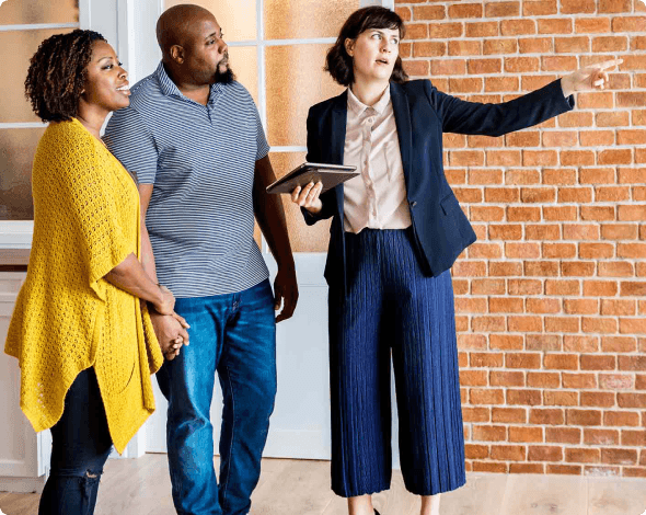 Image of a real estate broker touring a co-op home with prospective buyers.