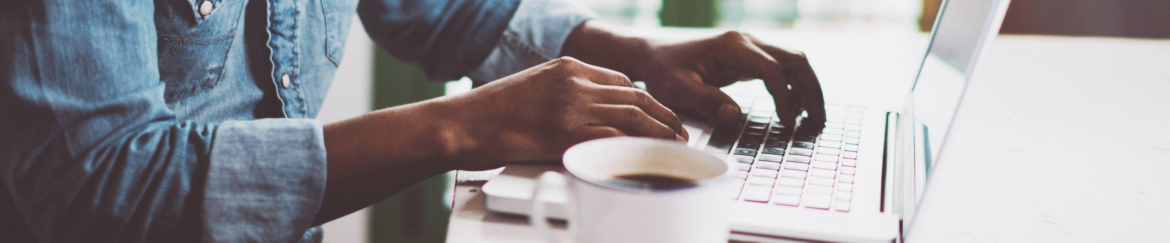 man typing on computer