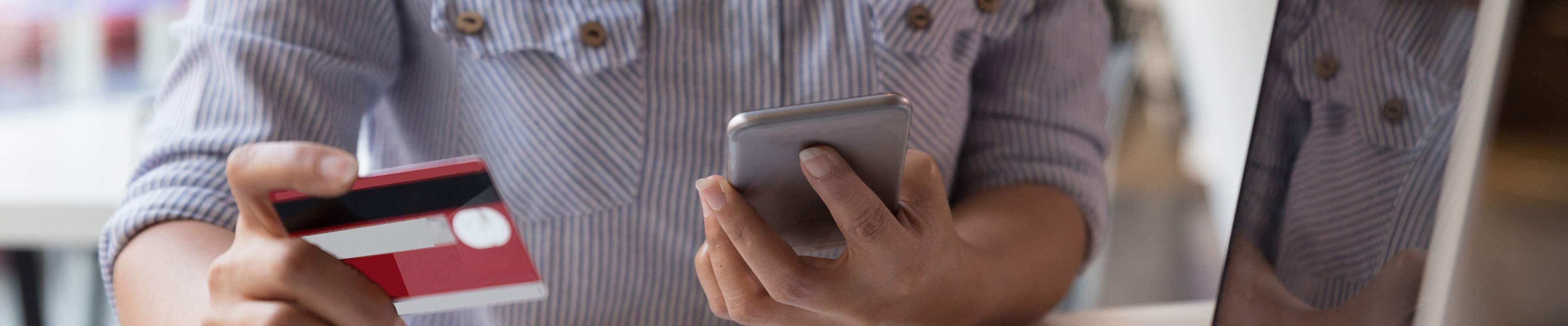 Image of an employee entering credit card data on a cell phone.