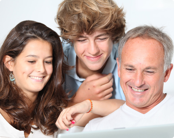Father and kids looking at life insurance on laptop