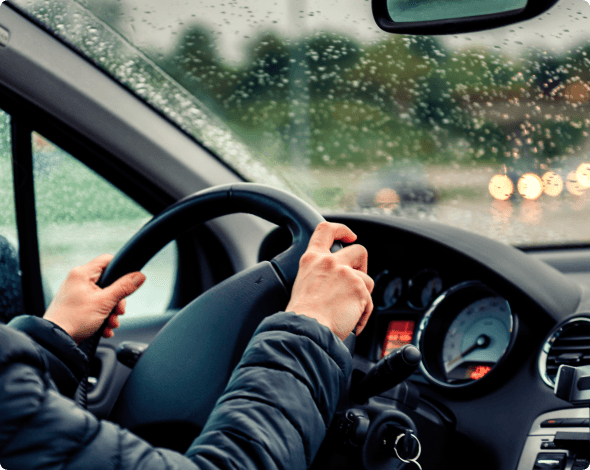 Driving holding steering wheel and glancing at the dashboard