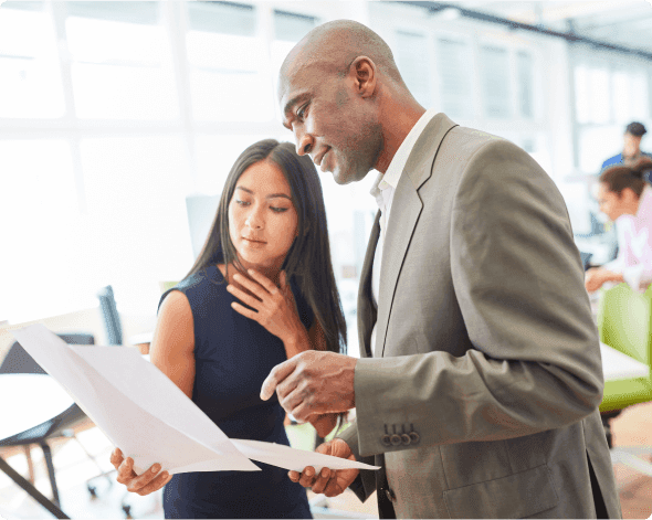 a man and a woman looking at a paper